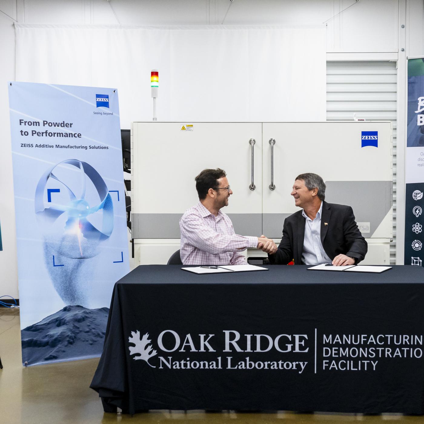 ZEISS Head of Additive Manufacturing Technology Claus Hermannstaedter, left, and ORNL Interim Associate Laboratory Director for Energy Science and Technology Rick Raines sign a licensing agreement that allows ORNL’s machine-learning algorithm, Simurgh, to be used for rapid evaluations of 3D-printed components with industrial X-ray computed tomography, or CT. Using machine learning in CT scanning is expected to reduce the time and cost of inspections of 3D-printed parts by more than ten times.