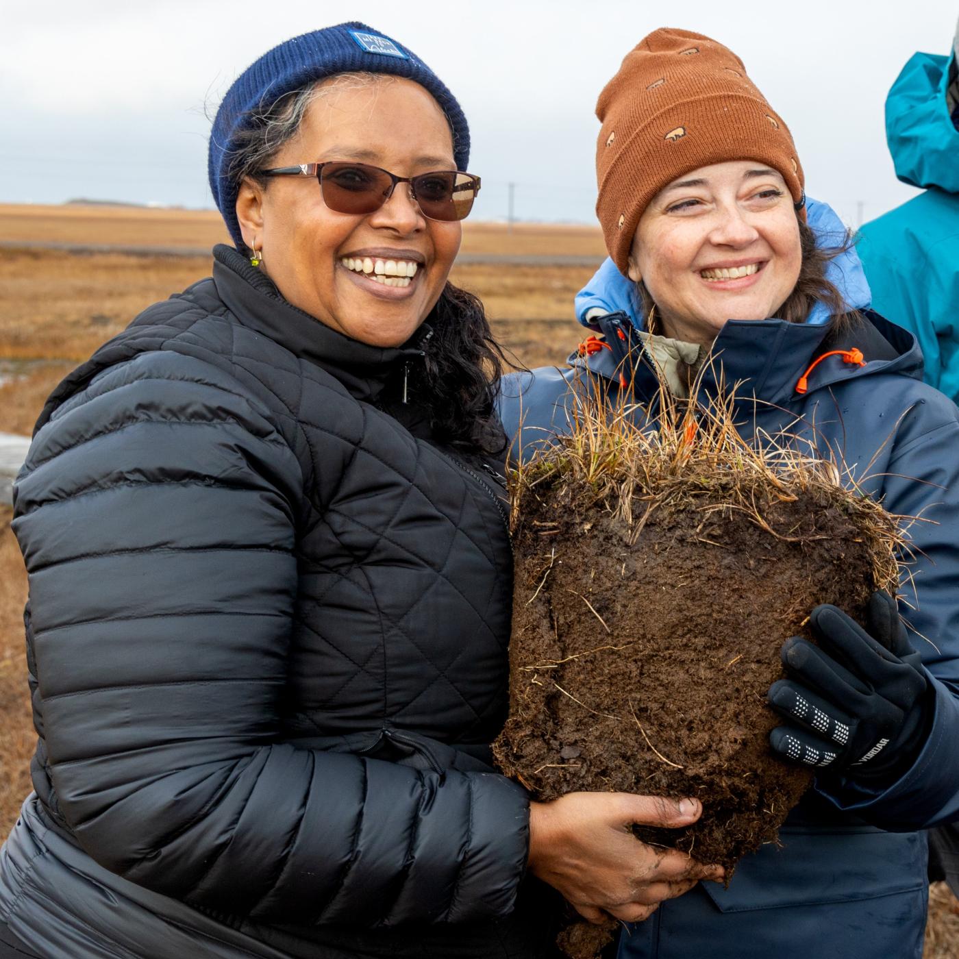 From left: DOE Office of Science Director Dr. Asmeret Asefaw Berhe with ORNL’s Colleen Iversen, director of NGEE Arctic, with a fresh soil sample collected near Utqiaġvik, Alaska. Credit: Genevieve Martin/ORNL, U.S. Dept. of Energy