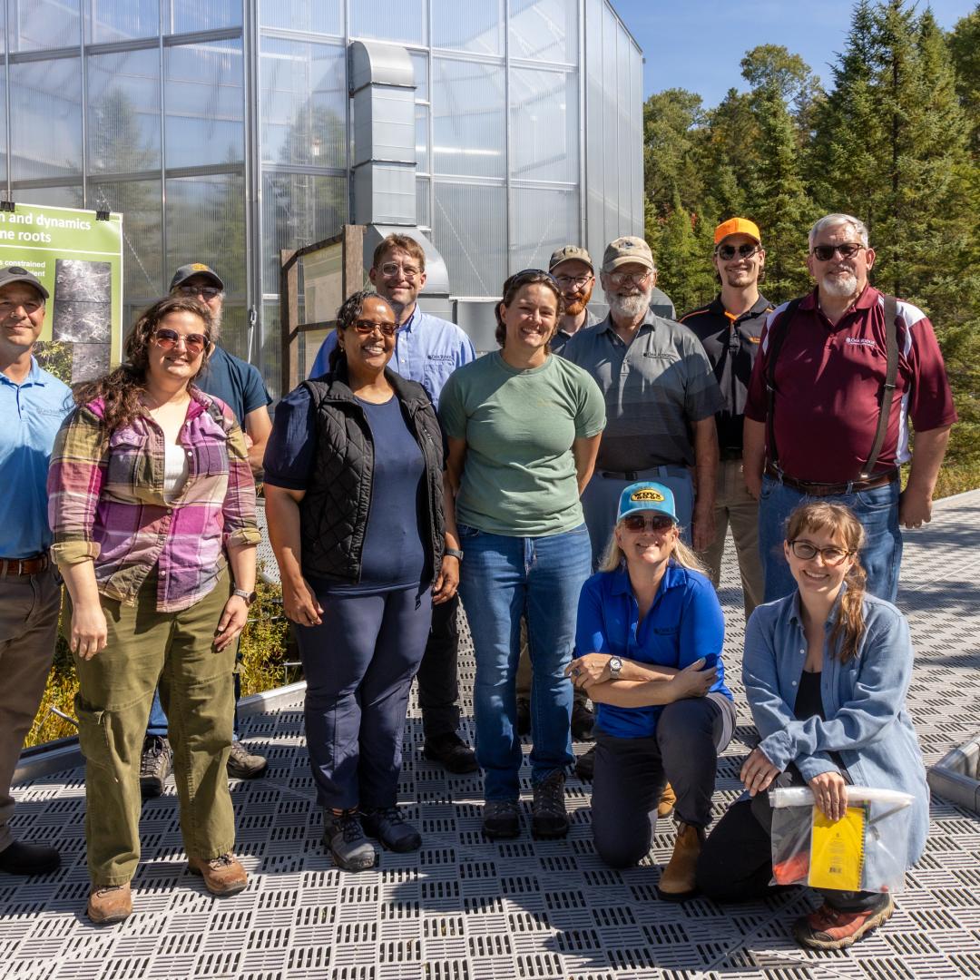 Front row: Victoria DiStefano and Dr. Asmeret Asefaw Berhe of DOE toured the SPRUCE experiment with Natalie Griffiths, Melanie Mayes, and Verity Salmon; back row: Dave Weston, Stephen Sebestyen (US Forest Service), Jonathan Stelling, Mark Guilliams, John Latimer (ORNL contractor), Kyle Pearson and Paul Hanson. Credit: Genevieve Martin/ORNL, U.S. Dept. of Energy
