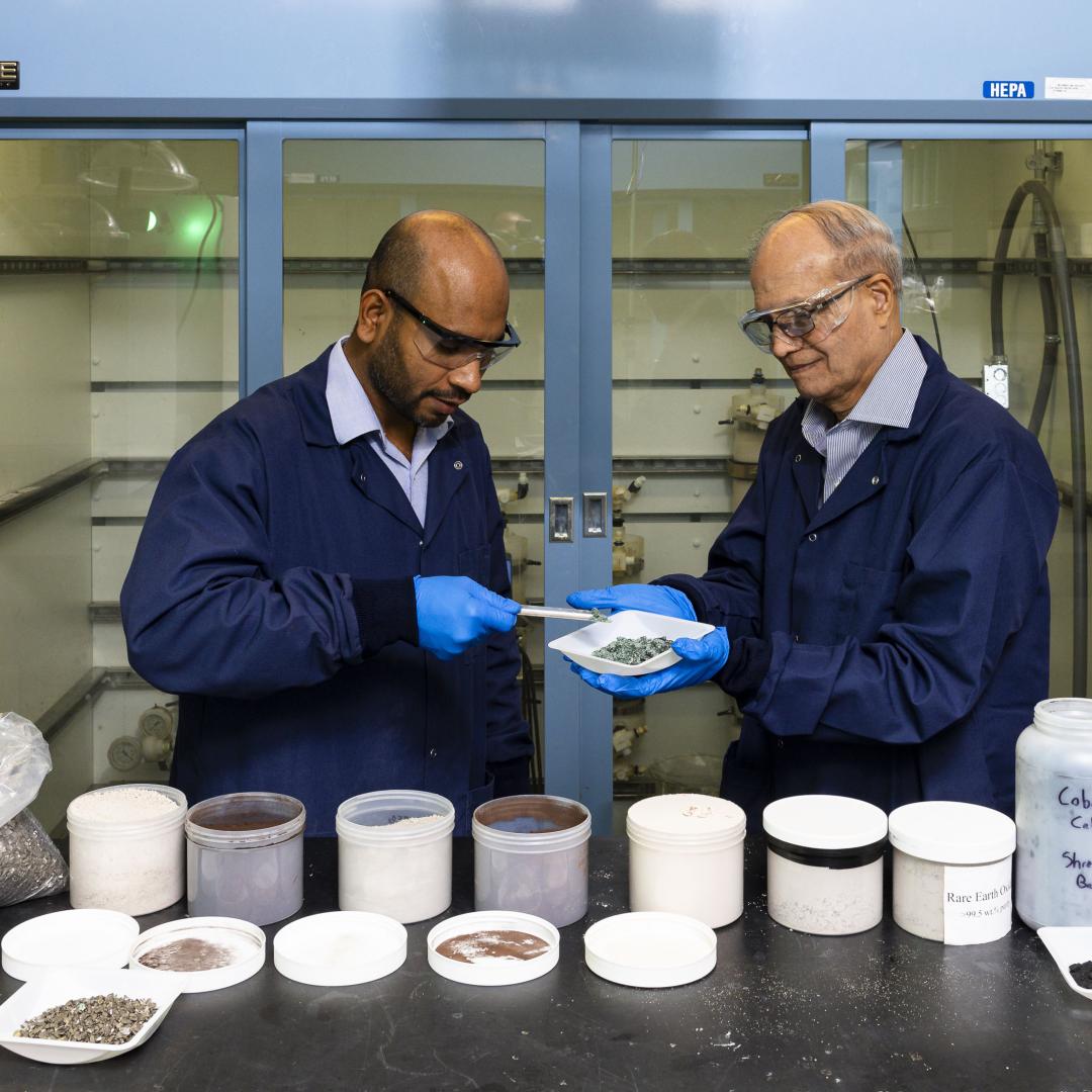 From left, researchers Syed Islam and Ramesh Bhave discuss the nickel sulfate recovered from end-of-life lithium-ion batteries using the membrane solvent extraction process they co-invented at ORNL. Credit: Carlos Jones/ORNL, U.S. Dept. of Energy