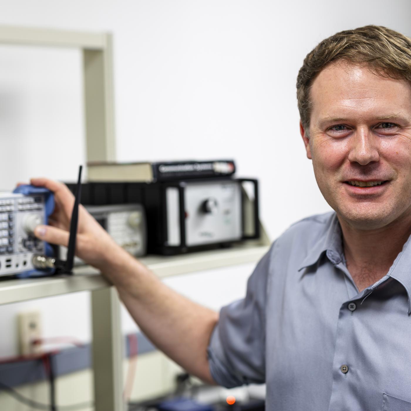 Corey Cooke is pictured standing next to radar technology