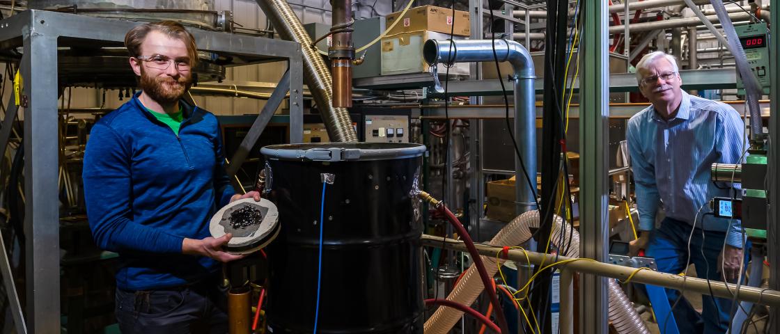ORNL fusion technology scientist Tim Bigelow, right, stands near the control console in ORNL’s fusion control room with Matt Houde of Quaise Energy. Their partnership aims to tackle technical challenges with the Millimeter Wave Drilling System that Quaise has developed. 