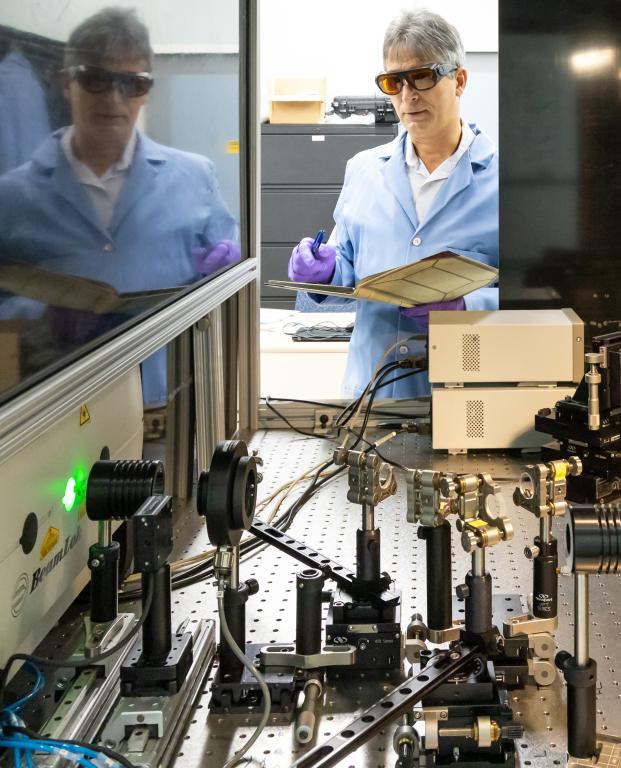 Adrian Sabau logs settings in a test of the laser-interference structuring system. Credit: Carlos Jones/ORNL, U.S. Dept. of Energy