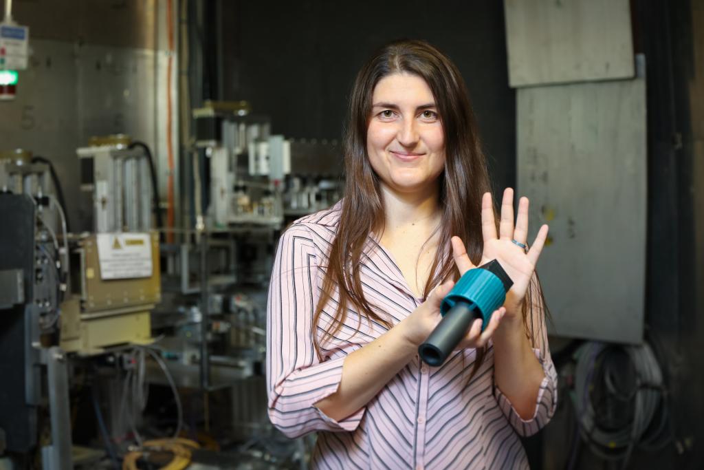 ORNL’s Leah Broussard shows a neutron absorbing wall that stops all neutrons but in theory would allow hypothetical mirror neutrons to pass through. Image credit: Genevieve Martin, ORNL