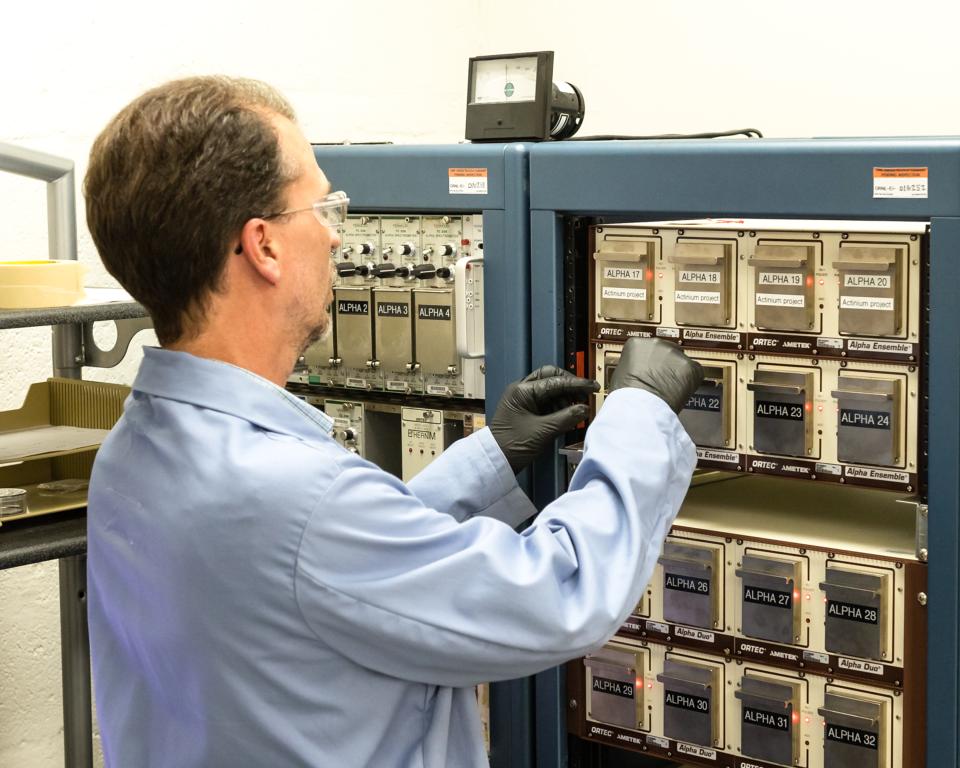 Marc Chattin of Oak Ridge National Laboratory uses an alpha spectrometer to analyze samples of isotopic plutonium with an ISO 17025-accredited method. Credit: Carlos Jones/ORNL, U.S. Dept. of Energy