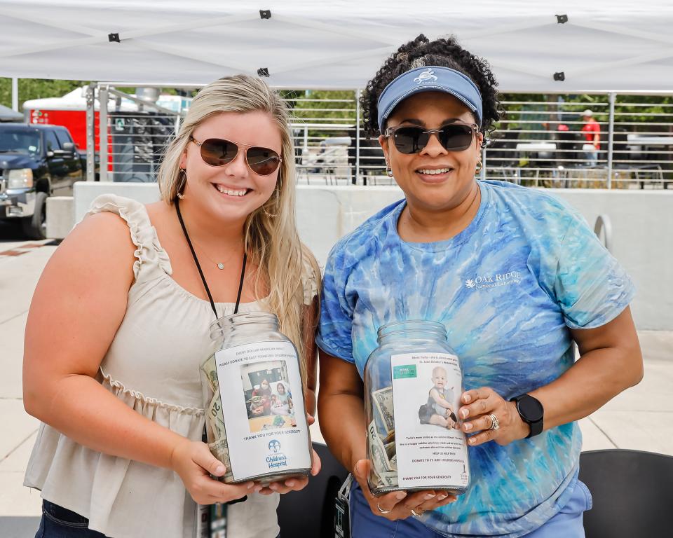 Two people collecting money for Children's Hospital at an ORNL Gives event
