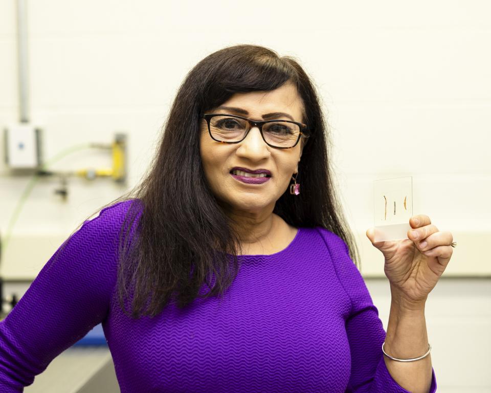 Madhavi Martin in the lab holding a sample 