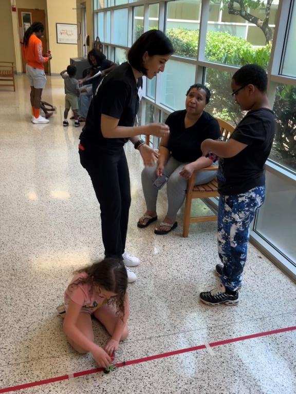 Students working with robots in school hallway.