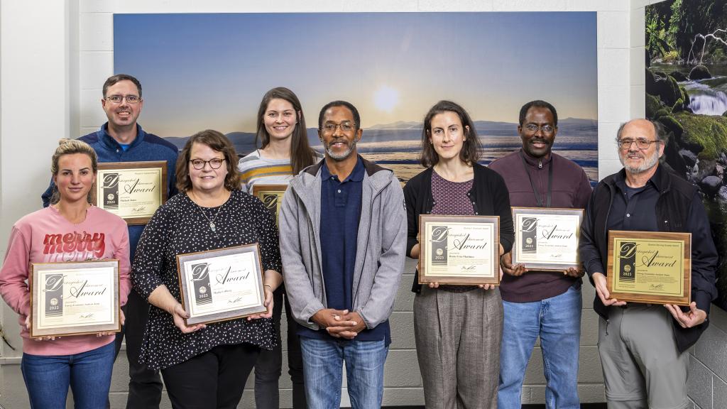 Environmental Sciences Division Director Eric Pierce presented the organization’s 2023 Distinguished Achievement awards at a December 7 all-hands meeting. From left: Megan Johnson, Michael Jones, Maria Colberg, Rachel Pilla, Eric Pierce, Rocio Uria-Martinez, Gbadebo Oladosu and Paul Leiby. Credit: Carlos Jones/ORNL, U.S. Dept. of Energy