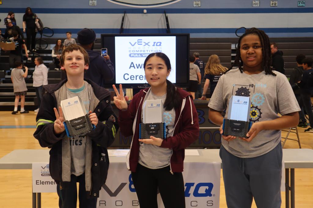 YO-STEM’s Team Radium members show their trophies for scores that placed them in this year’s state robotics competition for middle school. 