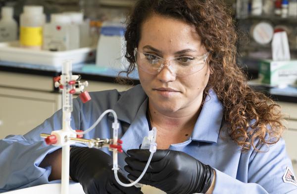 Allison Peacock using small equipment to build a generator, May 3, 2021.