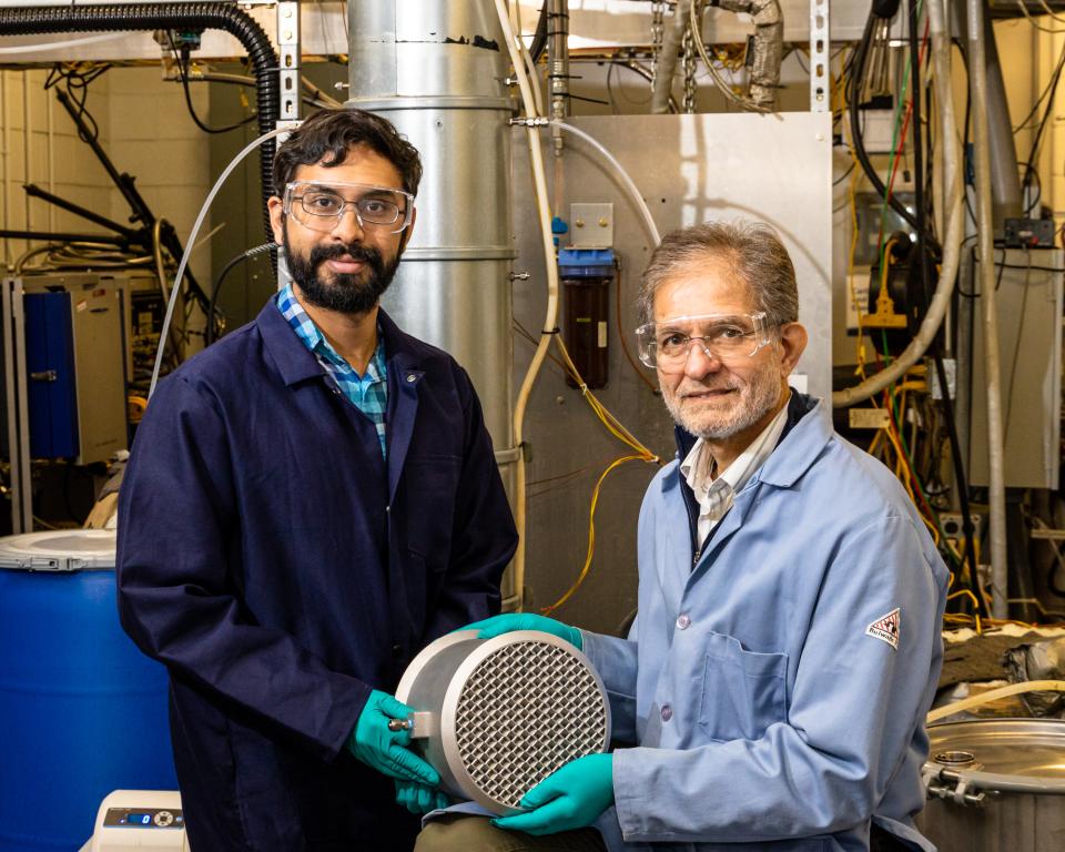 Eduardo Miramontes and Costas Tsouris in lab holding a 3d printed carbon capture device.