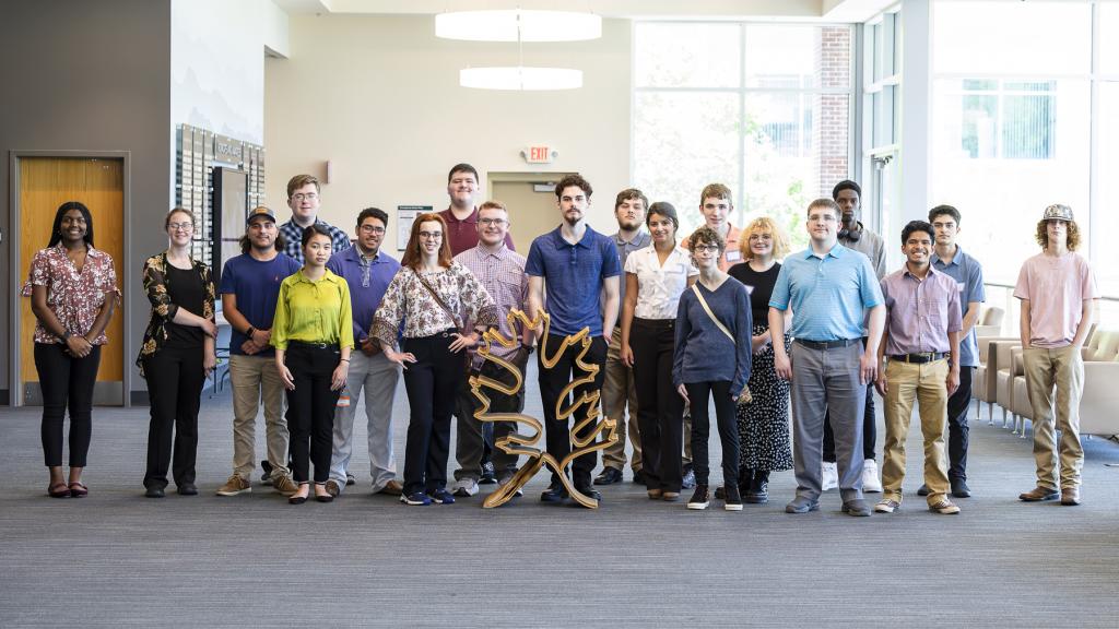 Students lined up for a group photo outside the conference room at ORNL.