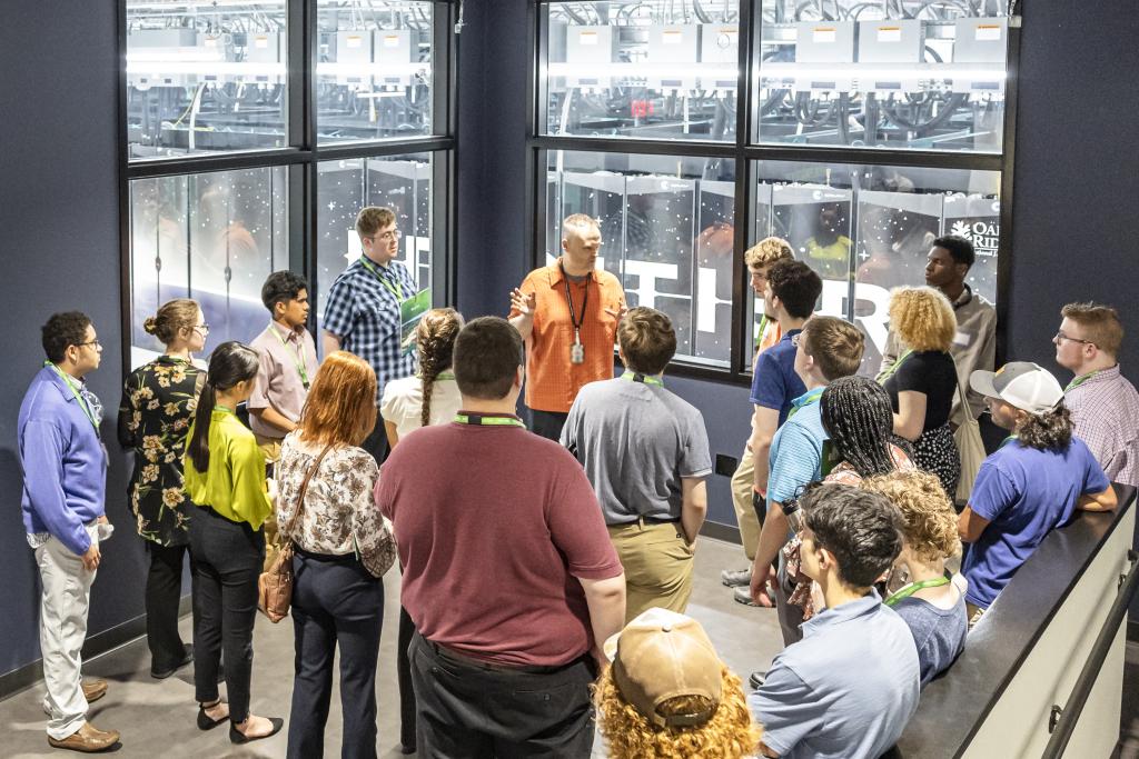 Students touring the observation area of the Frontier supercomputer.