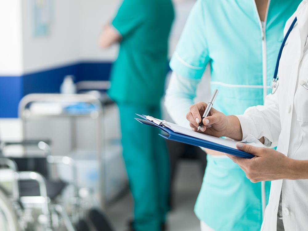 Doctor holding medical records (Envato Elements)