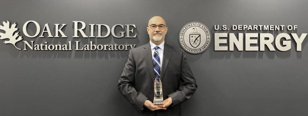 Mohamad Zineddin poses with the Roger Howsley Award