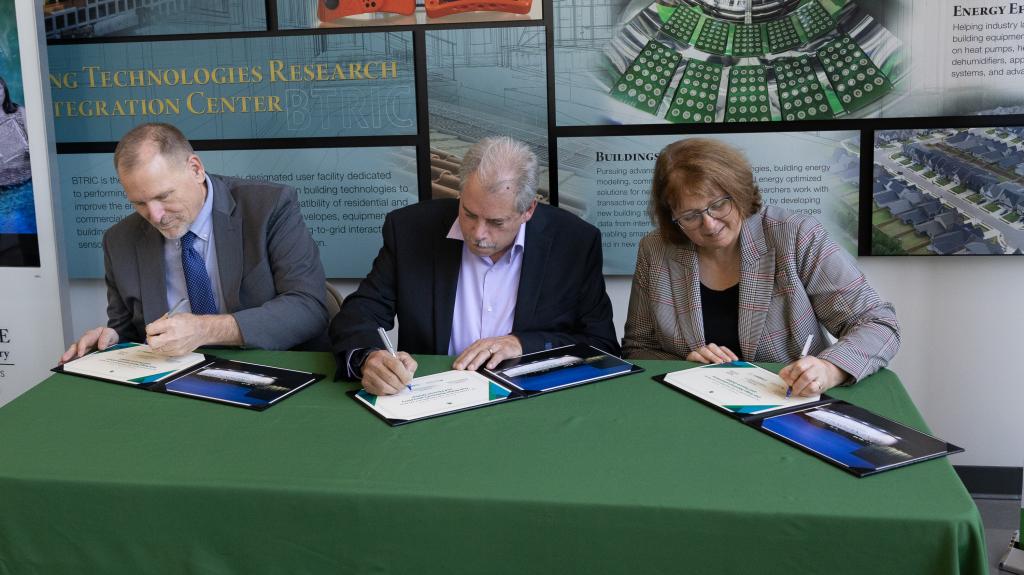 Wagner, Merwin and Jenks sign ceremonial licensing certificates.