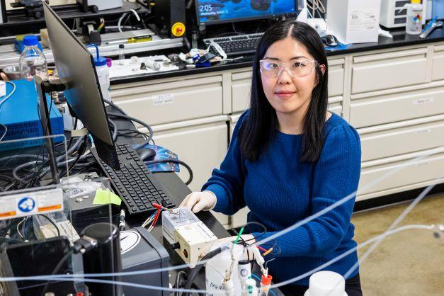 Mengya Li is pictured here sitting at a computer in a lab.