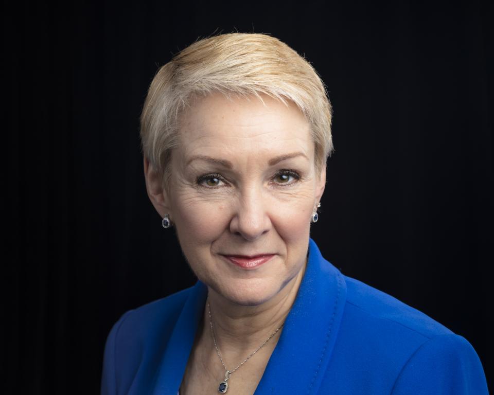 Kathryn McCarthy, director of the US ITER Project is pictured here posing against a black background. 