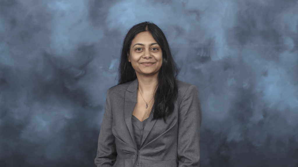 Ayana Ghosh is pictured here posing for a photo in a grey blazer