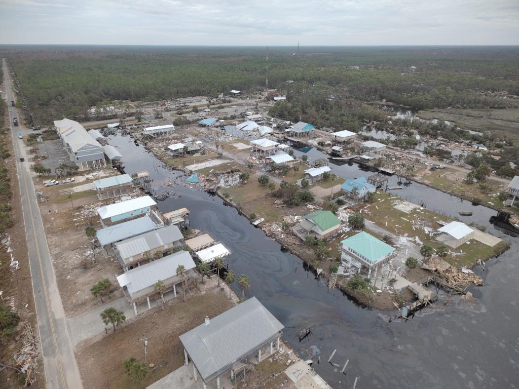 Arial view of hurricane aftermath looking down at damaged buildings and water