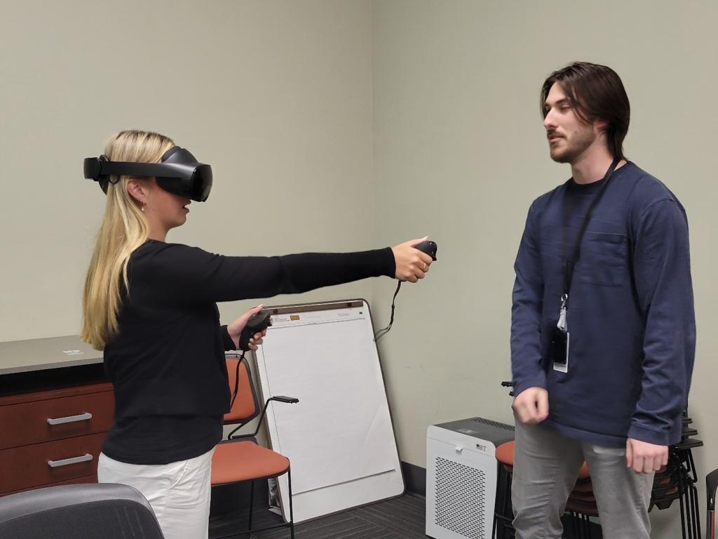 Two researchers demonstrating augmented reality tools.