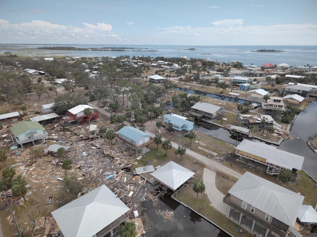 Images of damaged homes with debris on the ground