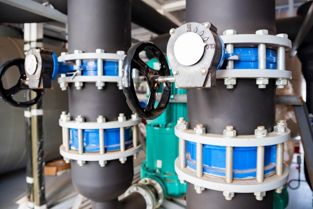 Close up black valves plug on plastic pipe. Image from Envato