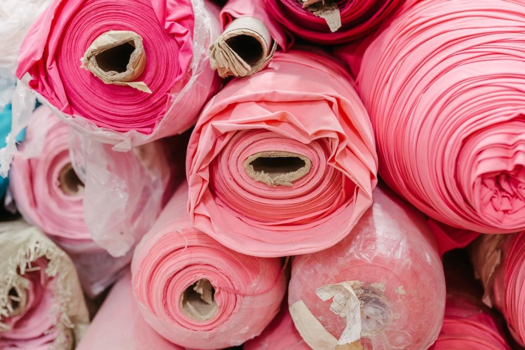 Vibrant collection of multicolored fabric rolls and swatches, arranged in a neat pile. Image from Envato