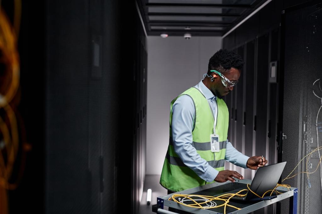 Graphic side view portrait of young network technician repairing servers in data center. Image from Envato