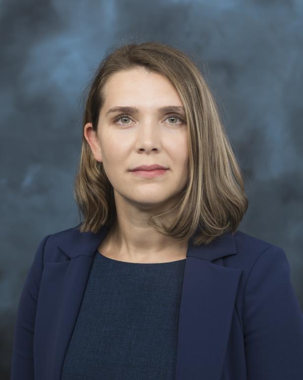 Organic chemist at ORNL, Santa Popova is posing for a photo with her hair down and in a navy blazer