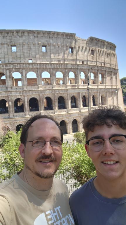 Researcher, Ryan Culler, and his ton take a selfie in front of the Roman Colosseum
