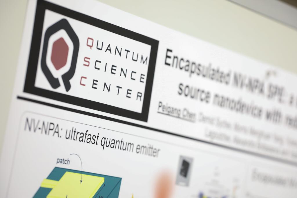 Close up image of Quantum Science Center poster with the QSC logo. 