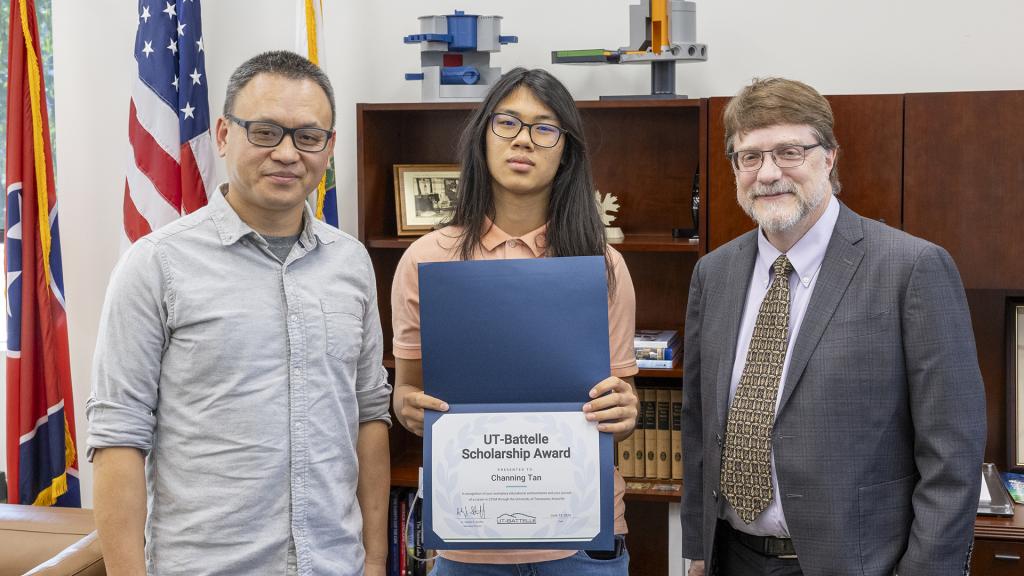 Laboratory Director Stephen Streiffer (right) congratulates UT-Battelle Scholarship recipient Channing Tan (center) and his father, Yugang Tan.
