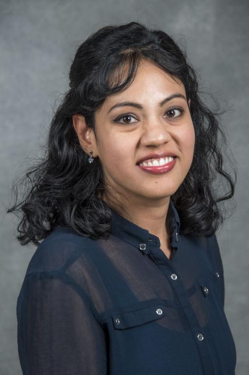 ORNL researcher Marium Kiran poses for a photo with a gray backdrop