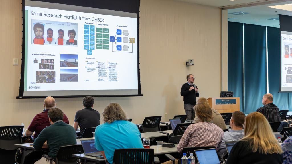 CAISER director is giving a presentation on AI security to a group of participants at the AI expo.