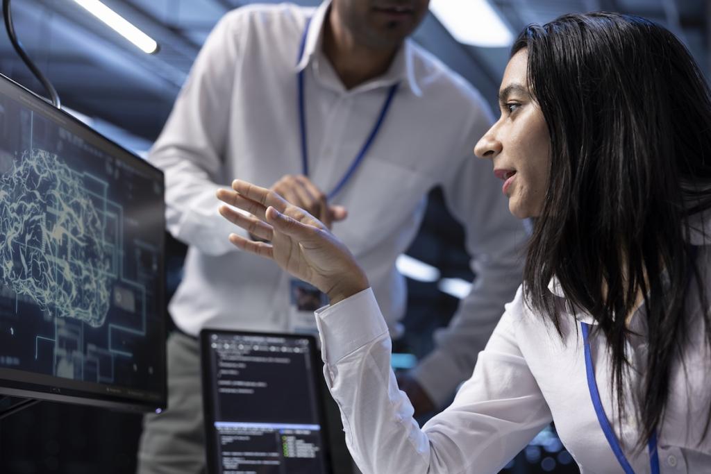 IT staff members in data center using PC to enable artificial intelligence to process datasets for training. Image from Envato
