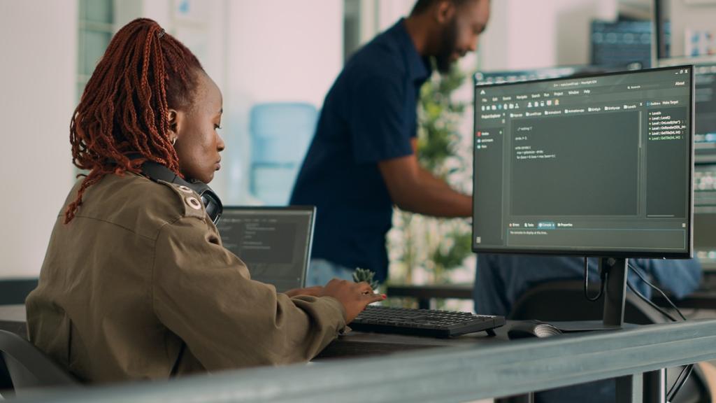 Software developer typing programming code on computer to develop online cloud computing information. Image from Envato