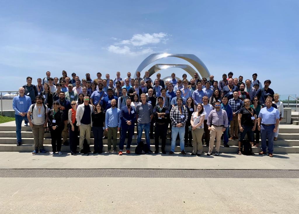 Large group photo outside on stairs at the Quantum Science Center all hands meeting.
