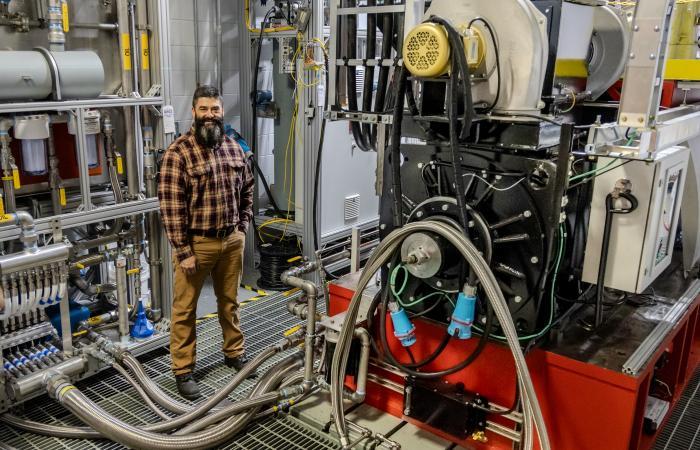 ORNL researcher Eric Nafziger works on the infrastructure support for a 40,000-pound locomotive research engine, shown here, designed to run on hydrogen.