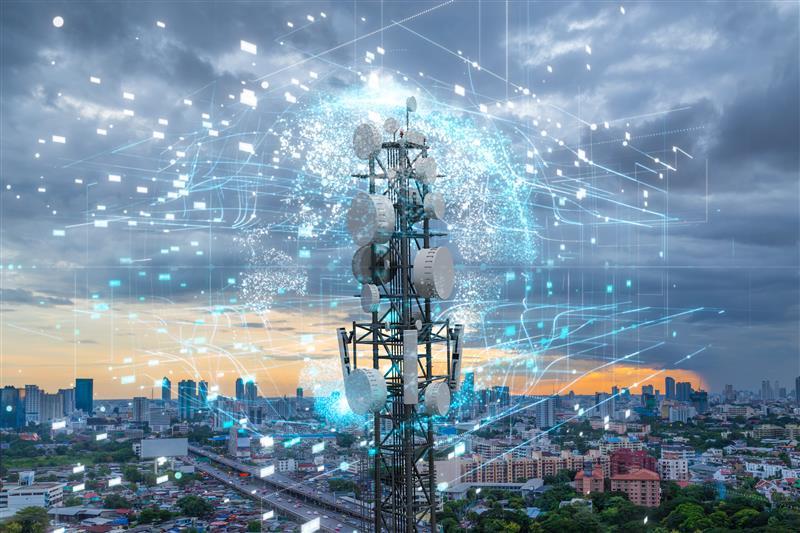 Telecommunication tower with city background. Image from Adobe Stock.