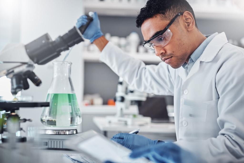 Science, chemistry and beaker with man in laboratory for research, DNA and vaccine analysis. Image from Envator