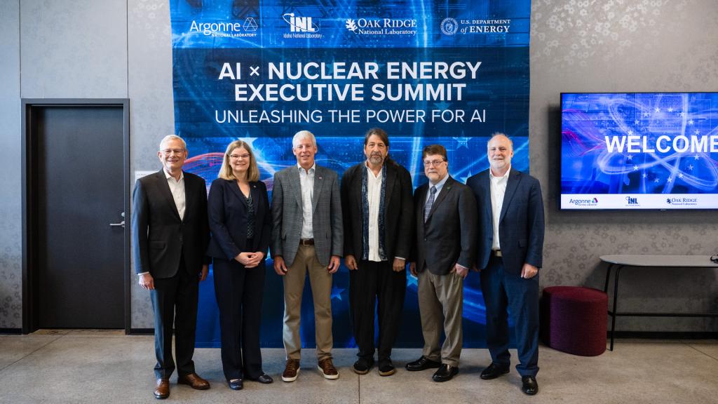 6 national laboratory leaders are standing in front of a sign that reads