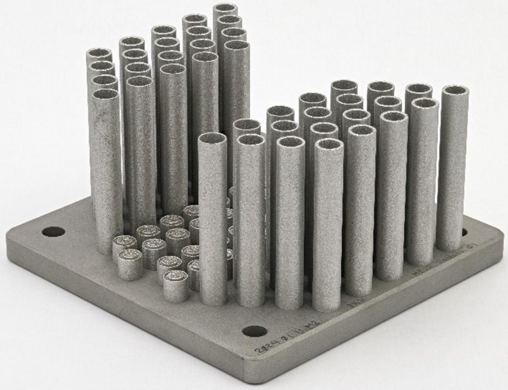 40 Stainless steel capsules 3D printed on a square board.