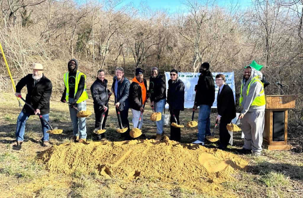 Group of people breaking ground on a new housing site