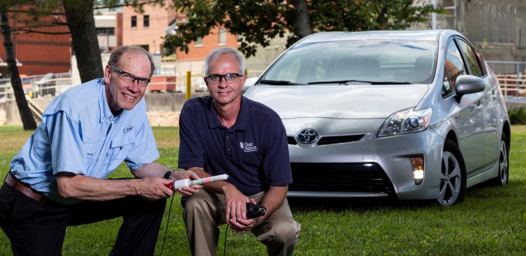 ORNL inventors Bruce Warmack, left, and Nance Ericson display an early prototype of the DC hotstick. Credit: Carlos Jones/Oak Ridge National Laboratory, U.S. Dept. of Energy.