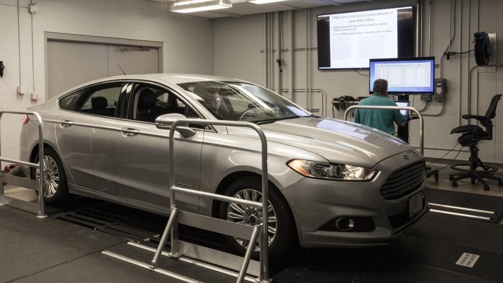 ORNL’s Frank Combs and Michael Starr of the U.S. Armed Forces (driver) work in ORNL’s Vehicle Security Laboratory to evaluate a prototype device that can detect network intrusions in all modern vehicles. Credit: Carlos Jones/ORNL, U.S. Dept. of Energy