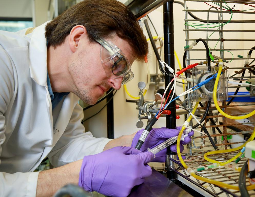Alex Lewis, a doctoral student with the Bredesen Center for Interdisciplinary Research and Education, samples a microbial electrolysis cell to measure hydrogen and proton concentrations. Alex Lewis, a doctoral student with the Bredesen Center for Interdisciplinary Research and Education, samples a microbial electrolysis cell to measure hydrogen and proton concentrations.