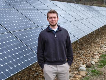 Ben Ollis standing in front of the ORNL Solar Array