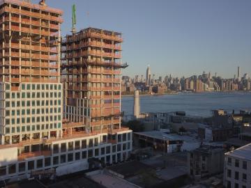 ORNL partnered with Gate Precast and used large-scale polymer deposition to 3D print precast concrete molds for the 42-story Domino Sugar Building in New York City. The molds and resulting concrete facades resemble the structure of sugar cubes. Credit: Gate Precast